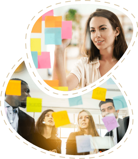 Using OneNote as a team: A woman sticks sticky notes to a glass wall, and a group of people discusses them.